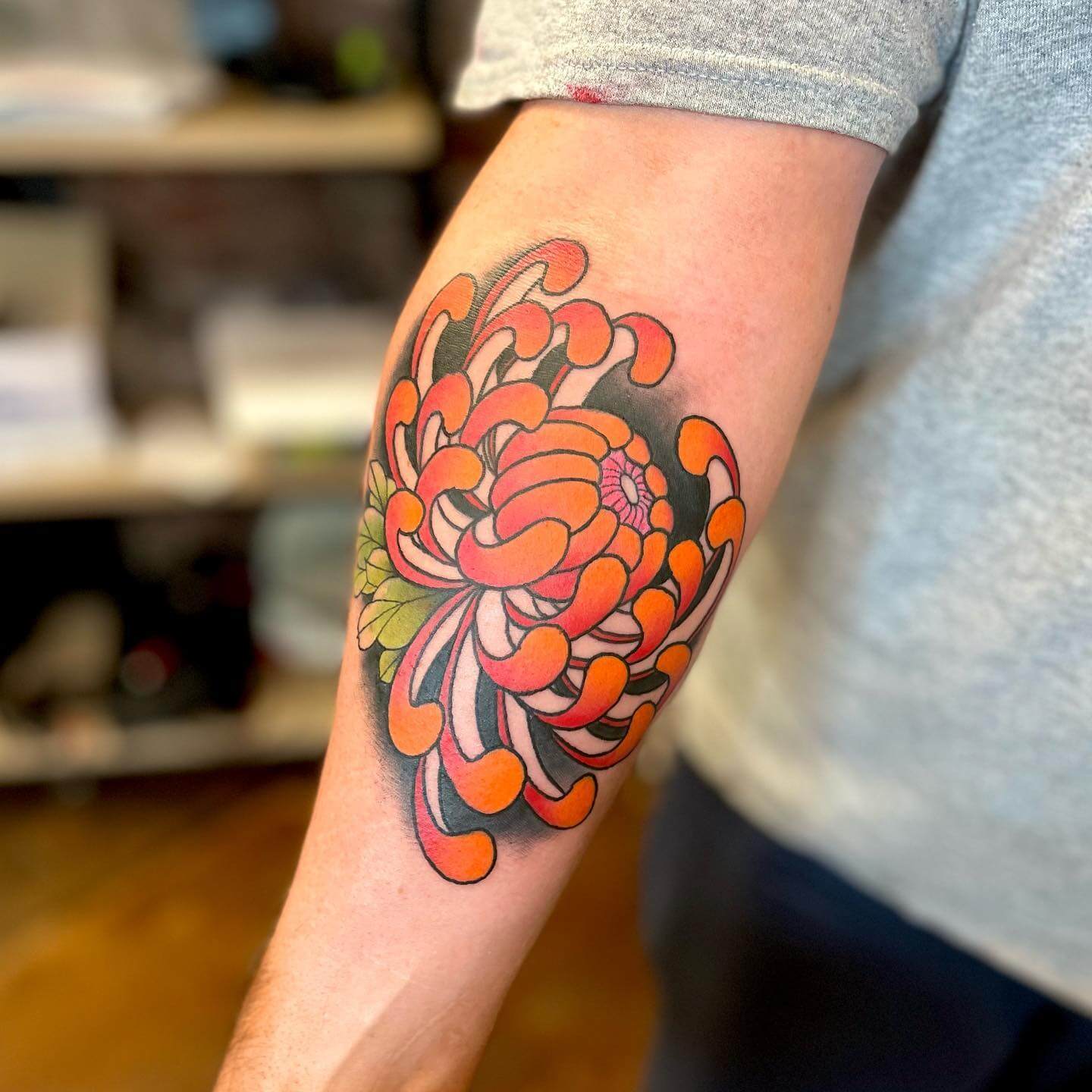 Traditional flowers tattoo on the inner forearm